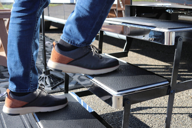 close-up shot of a person climbing into an RV, highlighting SeaDek RV step covers