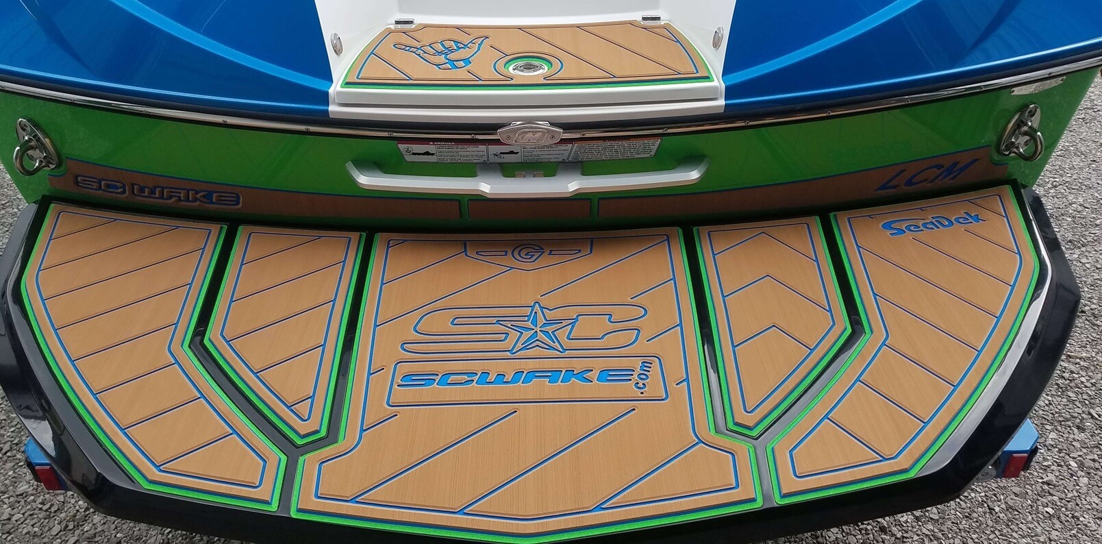 A swim platform on a Nautique boat that has a colorful SeaDek floor mat 